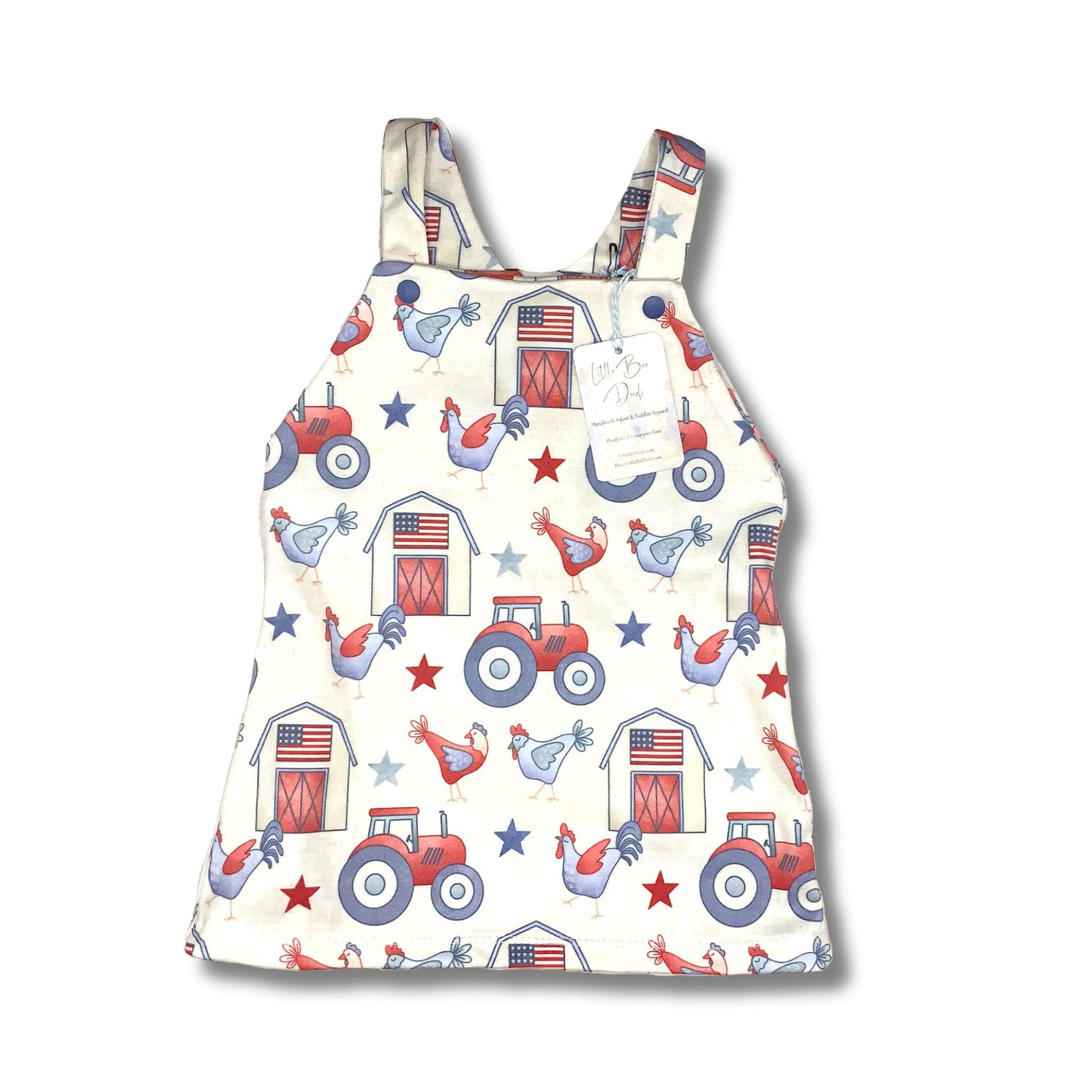 Jumper style dress for baby and toddler girls. Red, white and blue farm theme with varm, tractor and chickens on a cream background