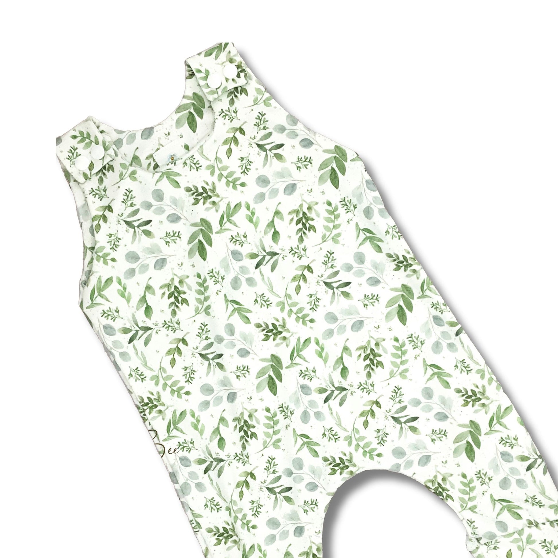 Long romper for baby and toddler girls with a watercolor green leaves print on a white background