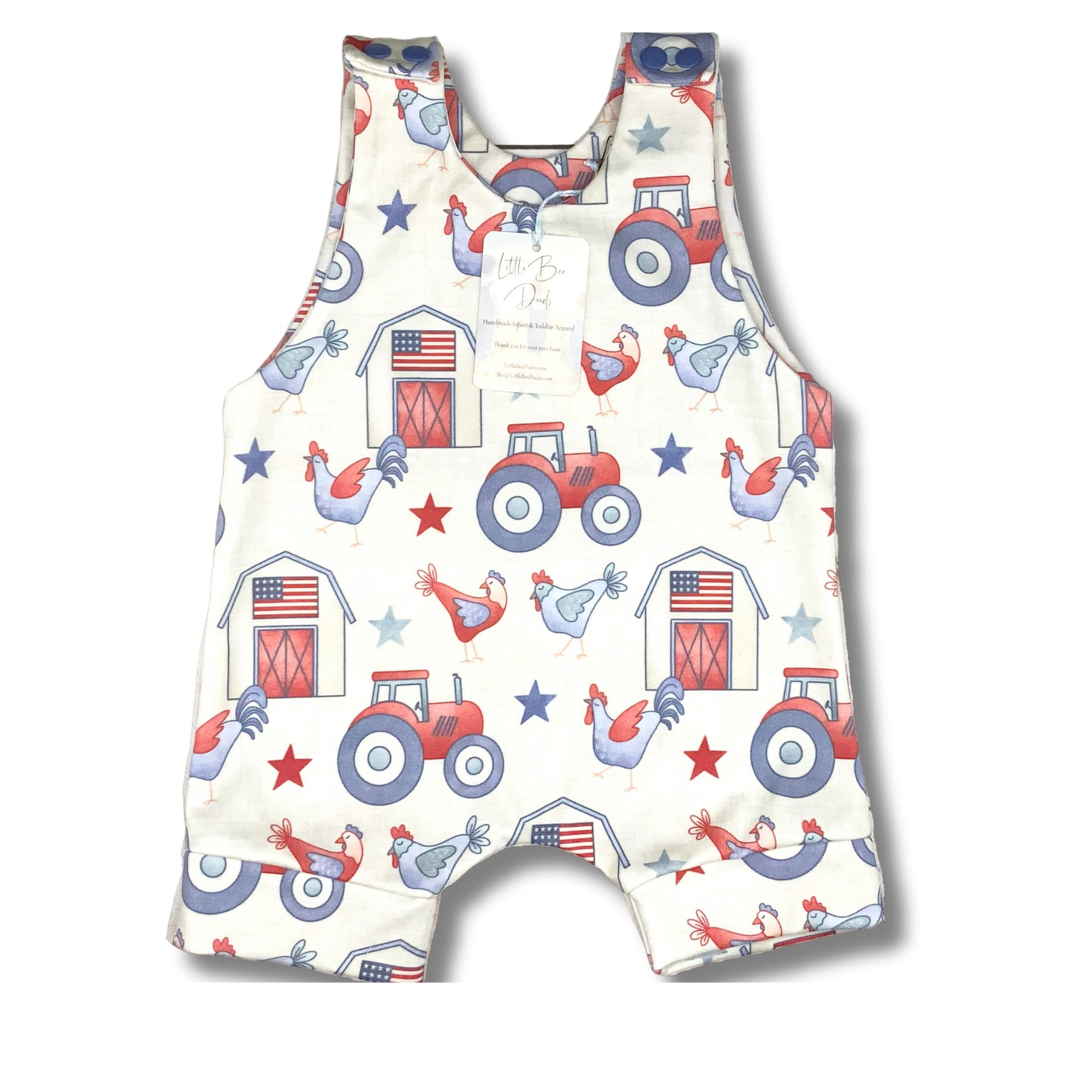 Short romper with red, white and blue patriotic farm themed print. Tractors, chickens with a barn with an American Flag